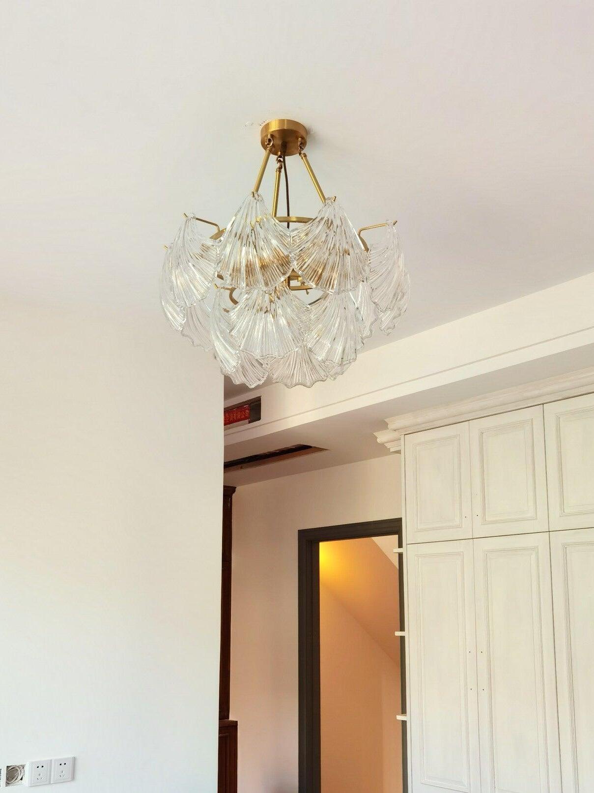 Low-angle view of the ribbed glass ceiling light near a white wall and doorway