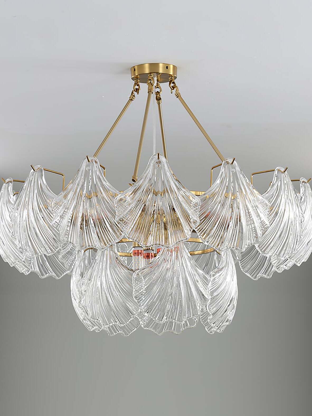 Unlit broad round fixture showing the overlapping fan-shaped ribbed glass panels