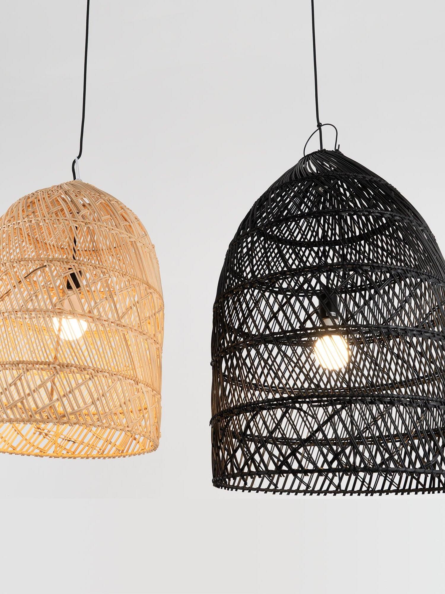 Two elongated rattan pendants with glowing bulbs