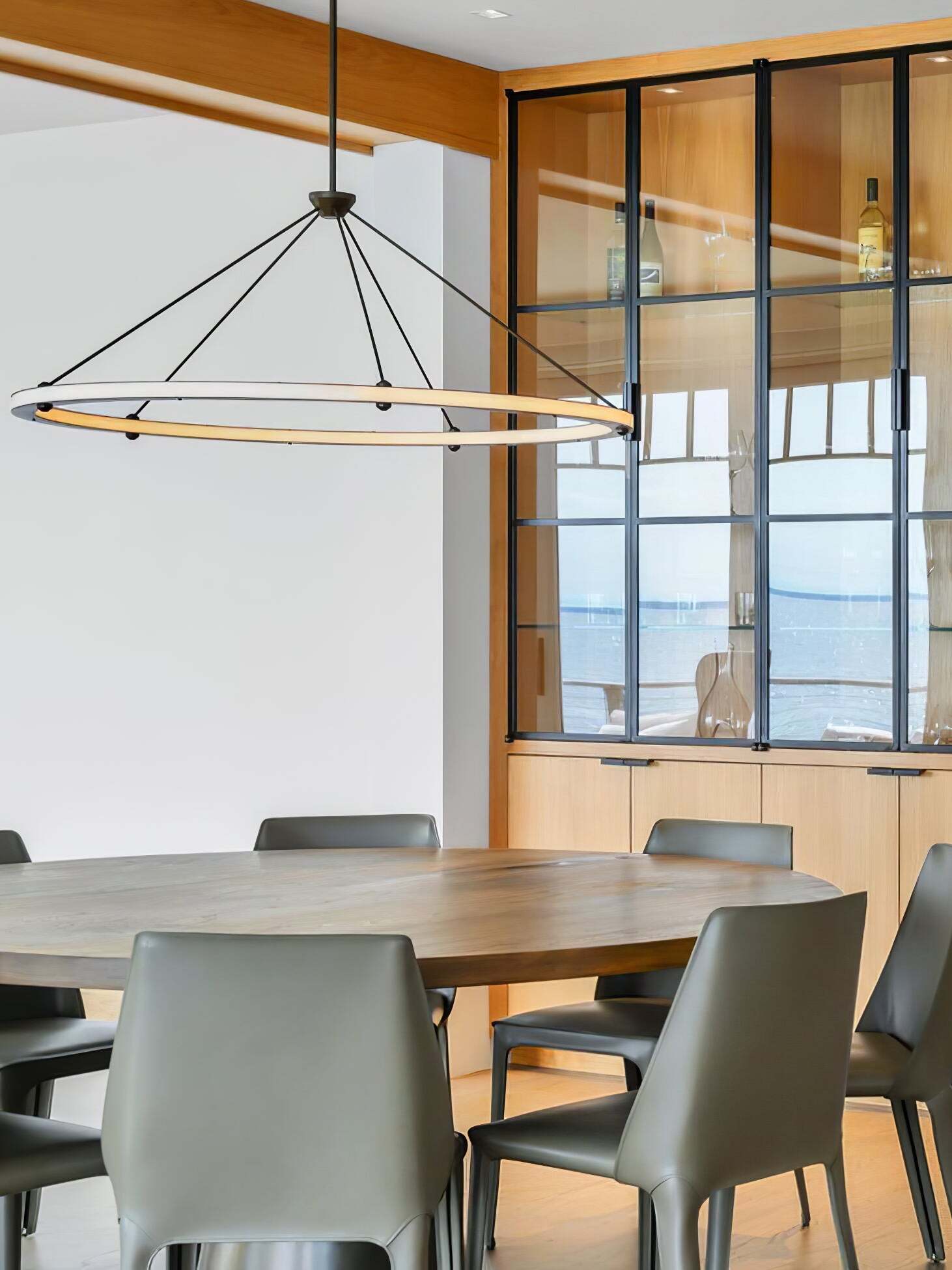 Black ring ceiling pendant above dining table