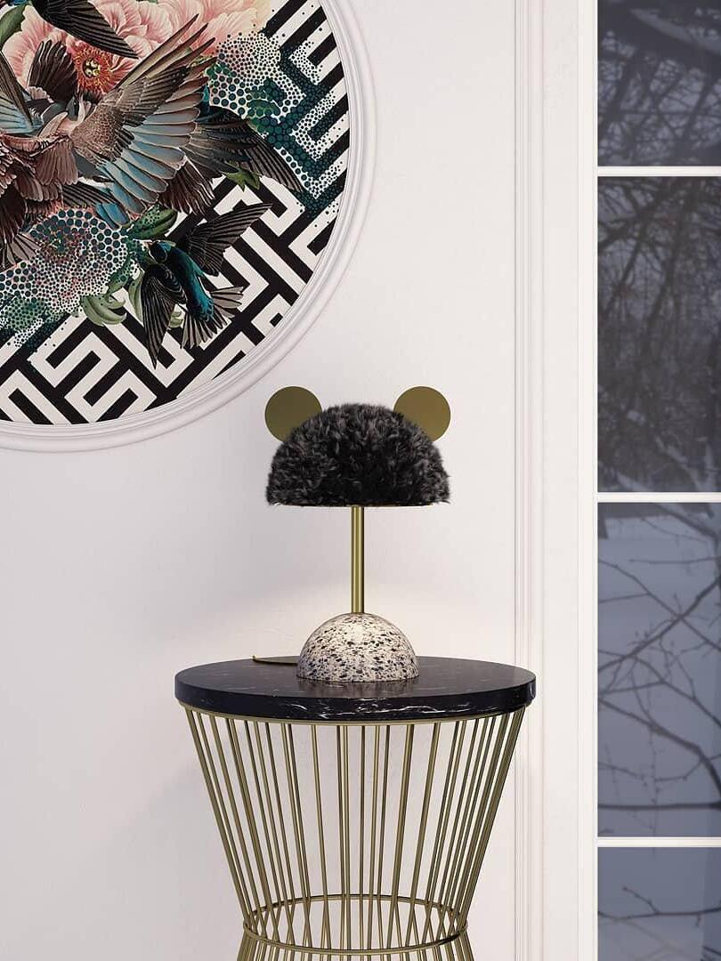 Dark plush shade lamp on wire side table near window and wall art