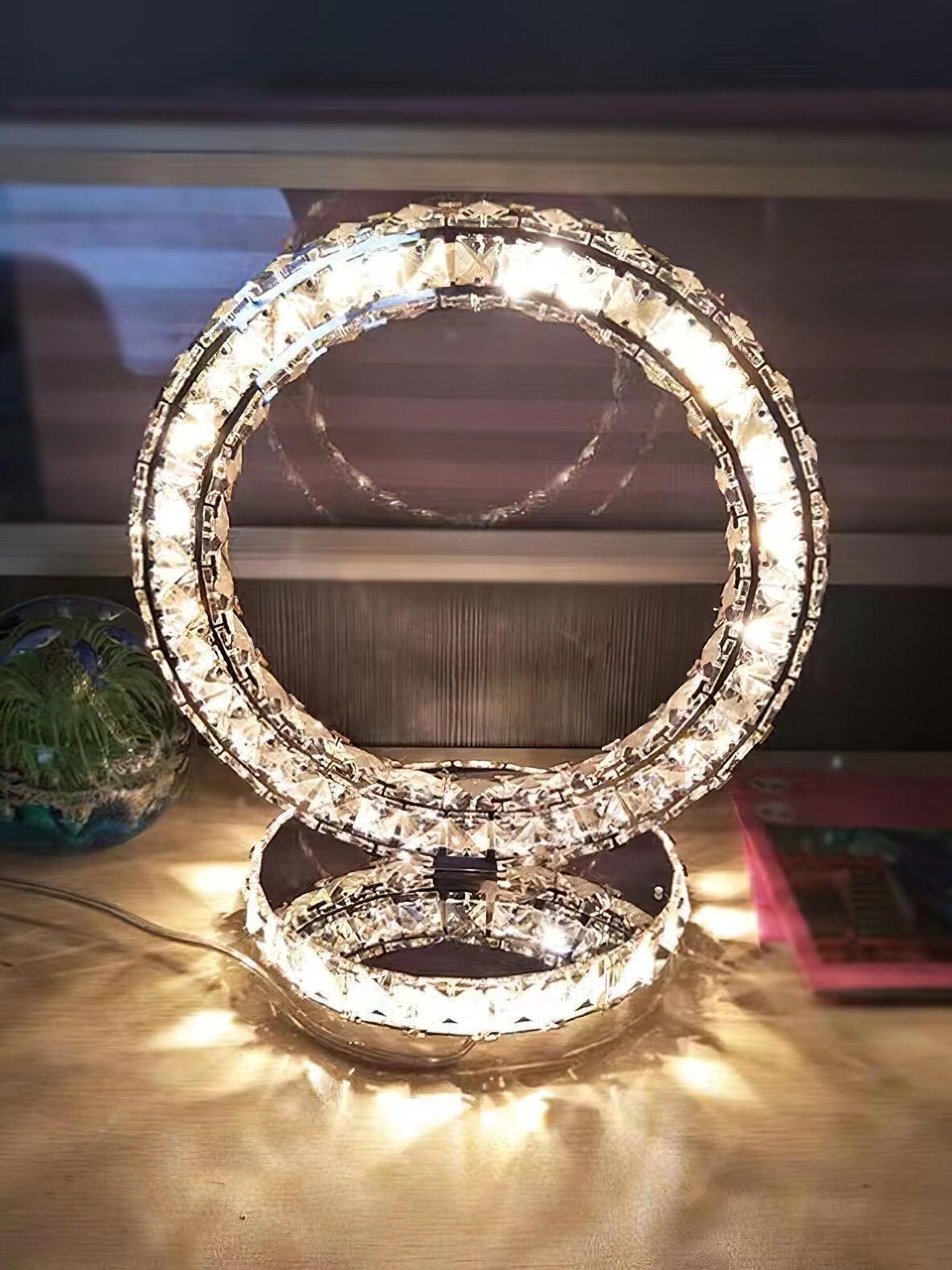 Warm-looking illuminated ring lamp on a table with light patterns around the round base