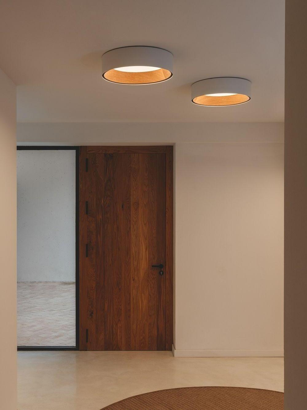 Two white round ceiling lights in hallway