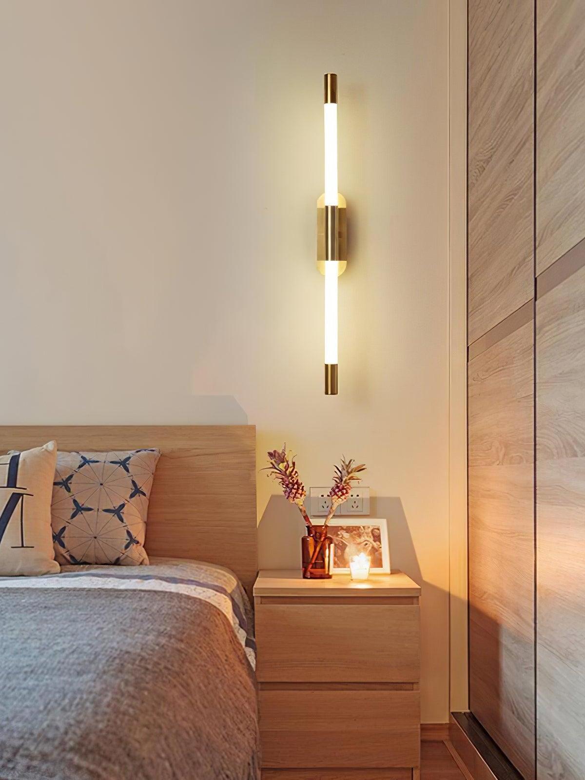 Gold Agnes wall light above a bedside table near wood wall panelling