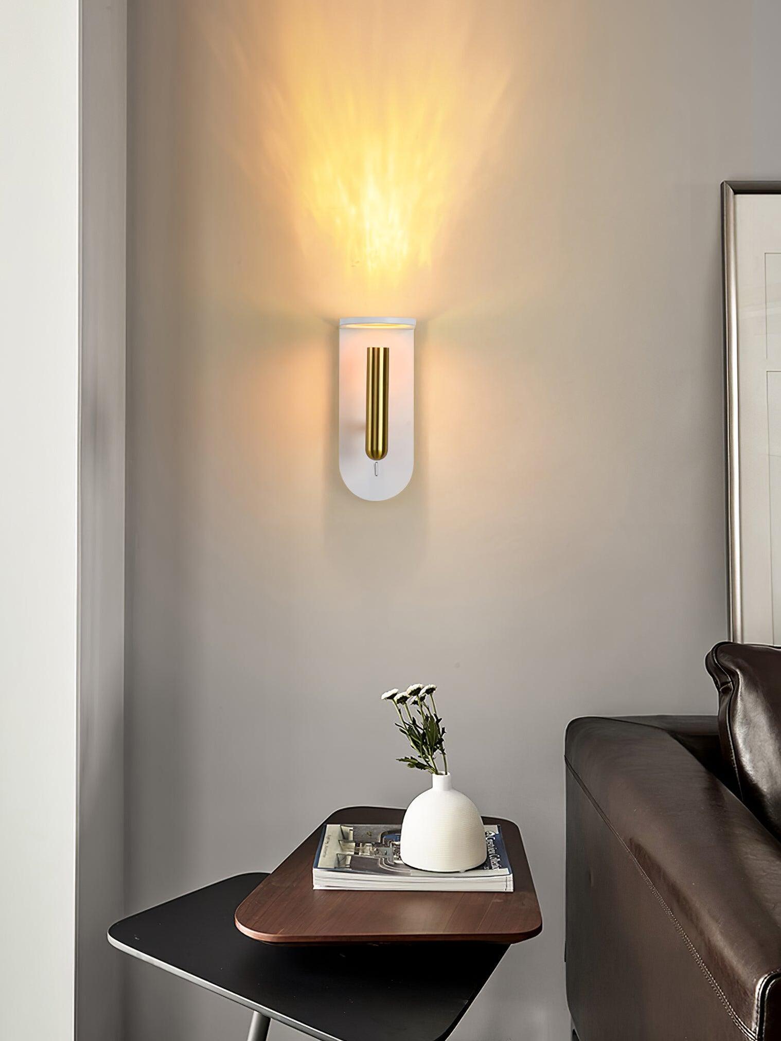 White Nights wall light above a bedside cabinet beside a dark upholstered bed