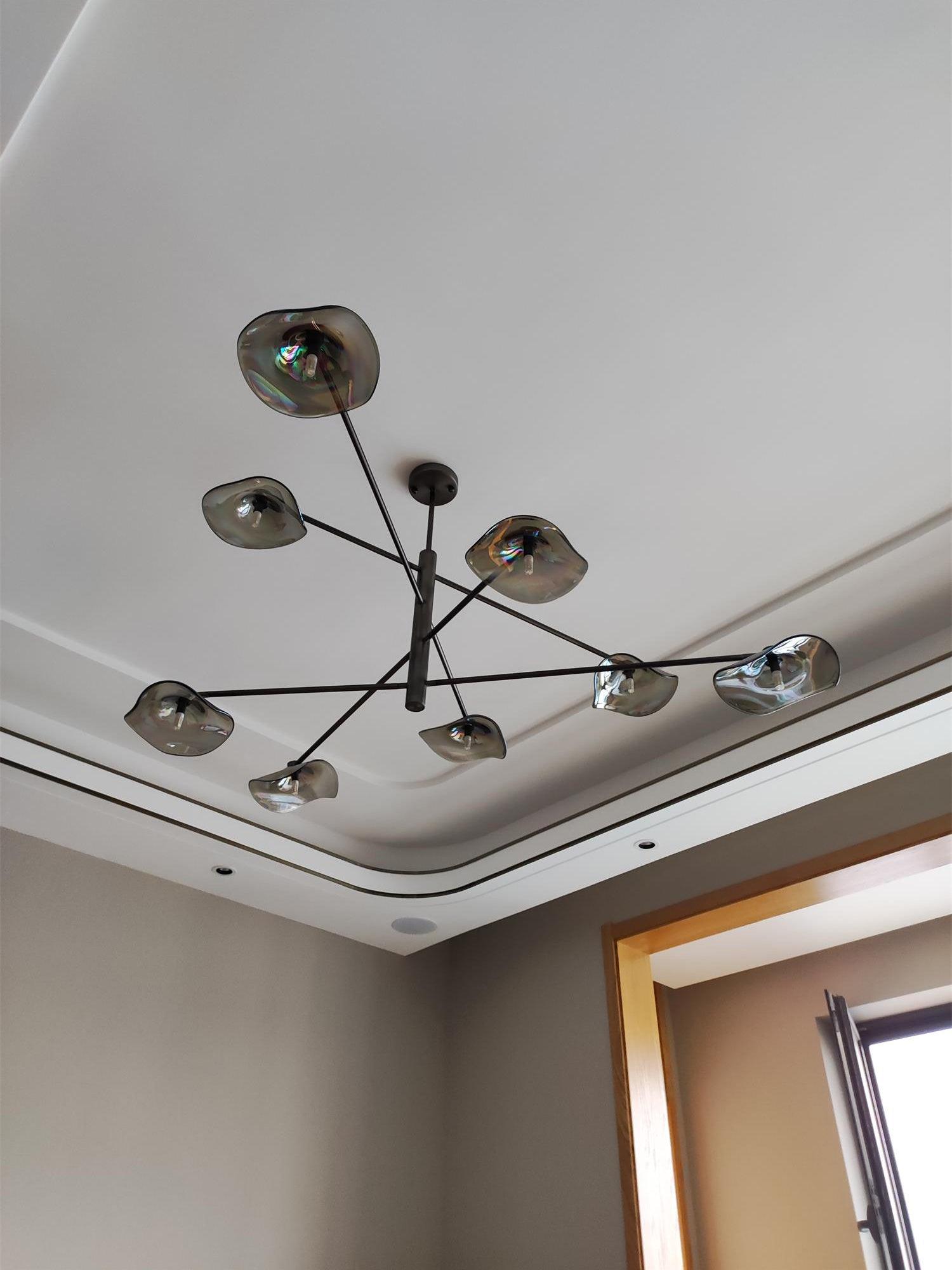 Low-angle view of Black frame and wavy glass shades