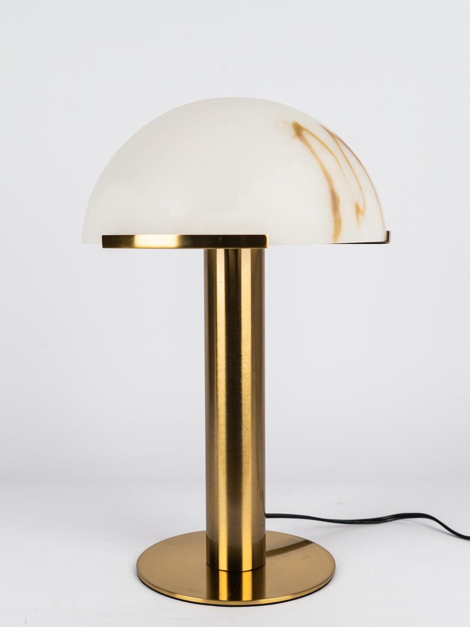 Gold table lamp with veined dome and visible cord