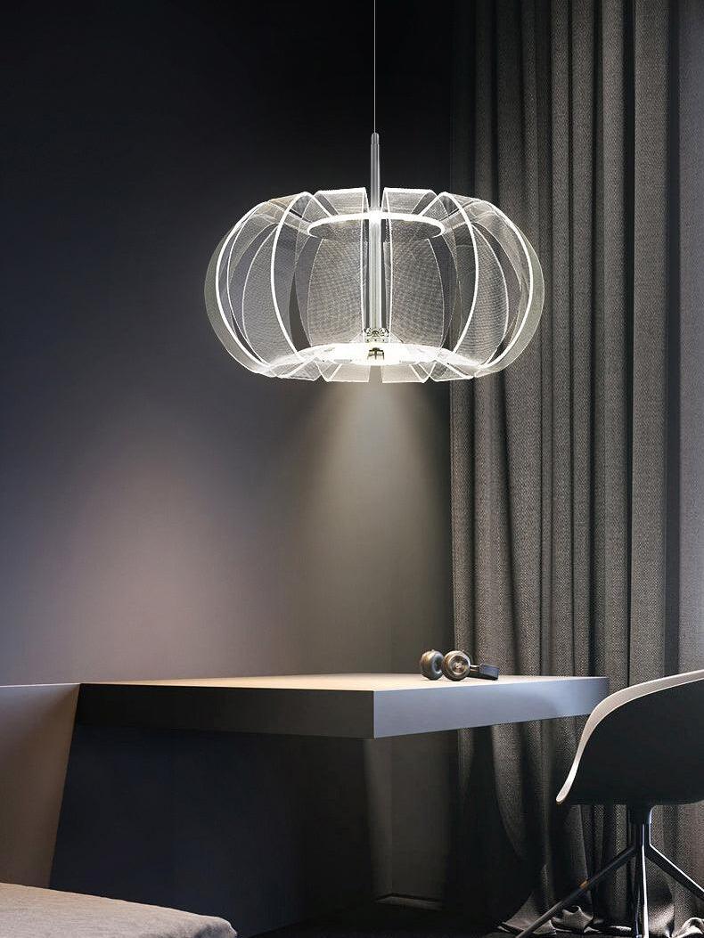 Clear ribbed LED pendant above a desk with headphones beside a grey curtain