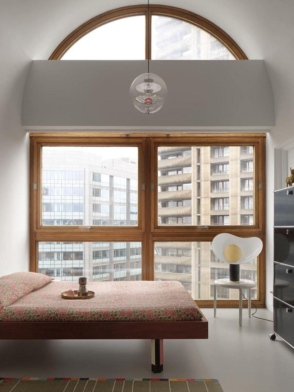 Small table lamp on cabinet beside bedroom window