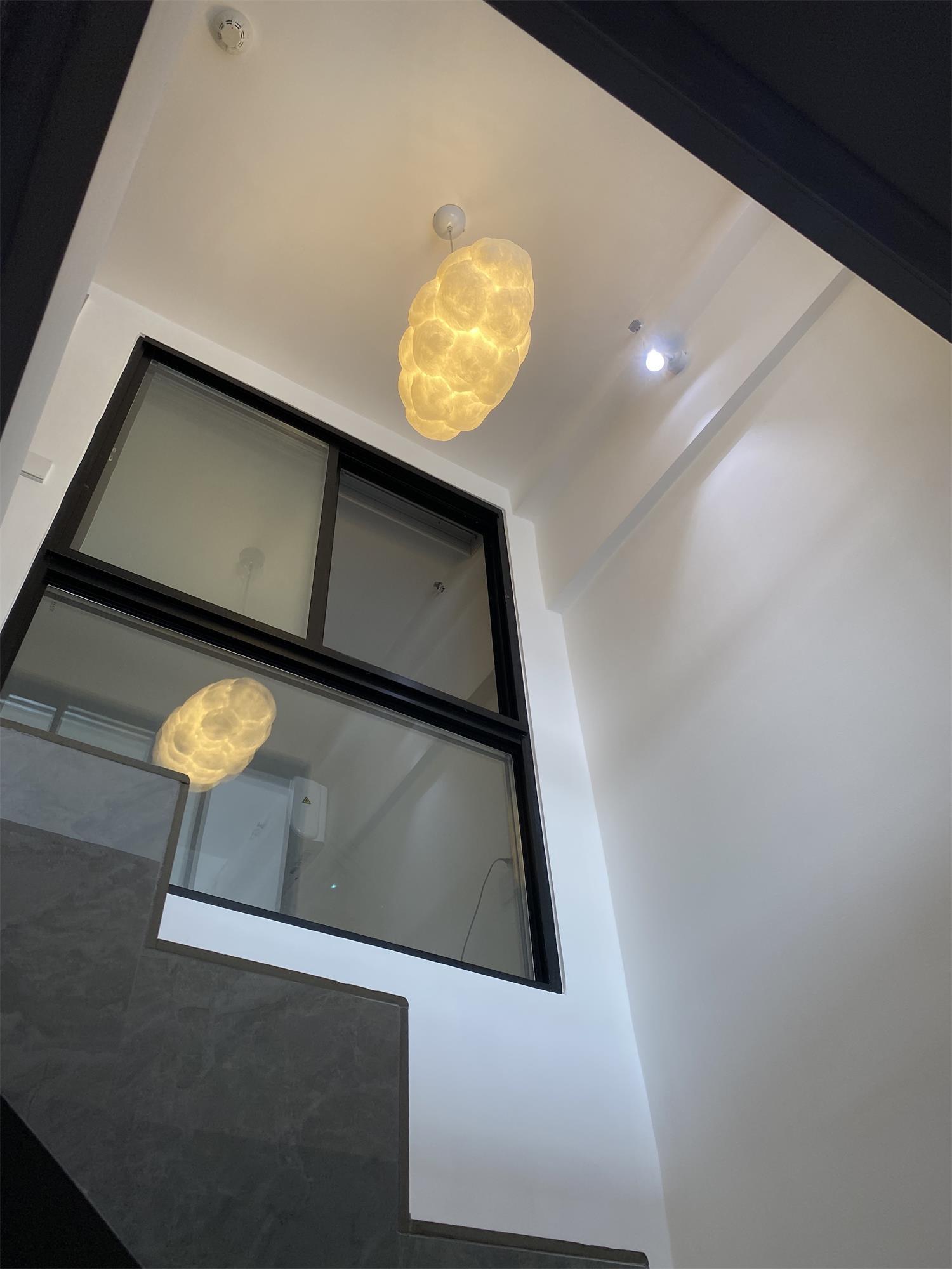 Cloud lights at different heights in a stairwell