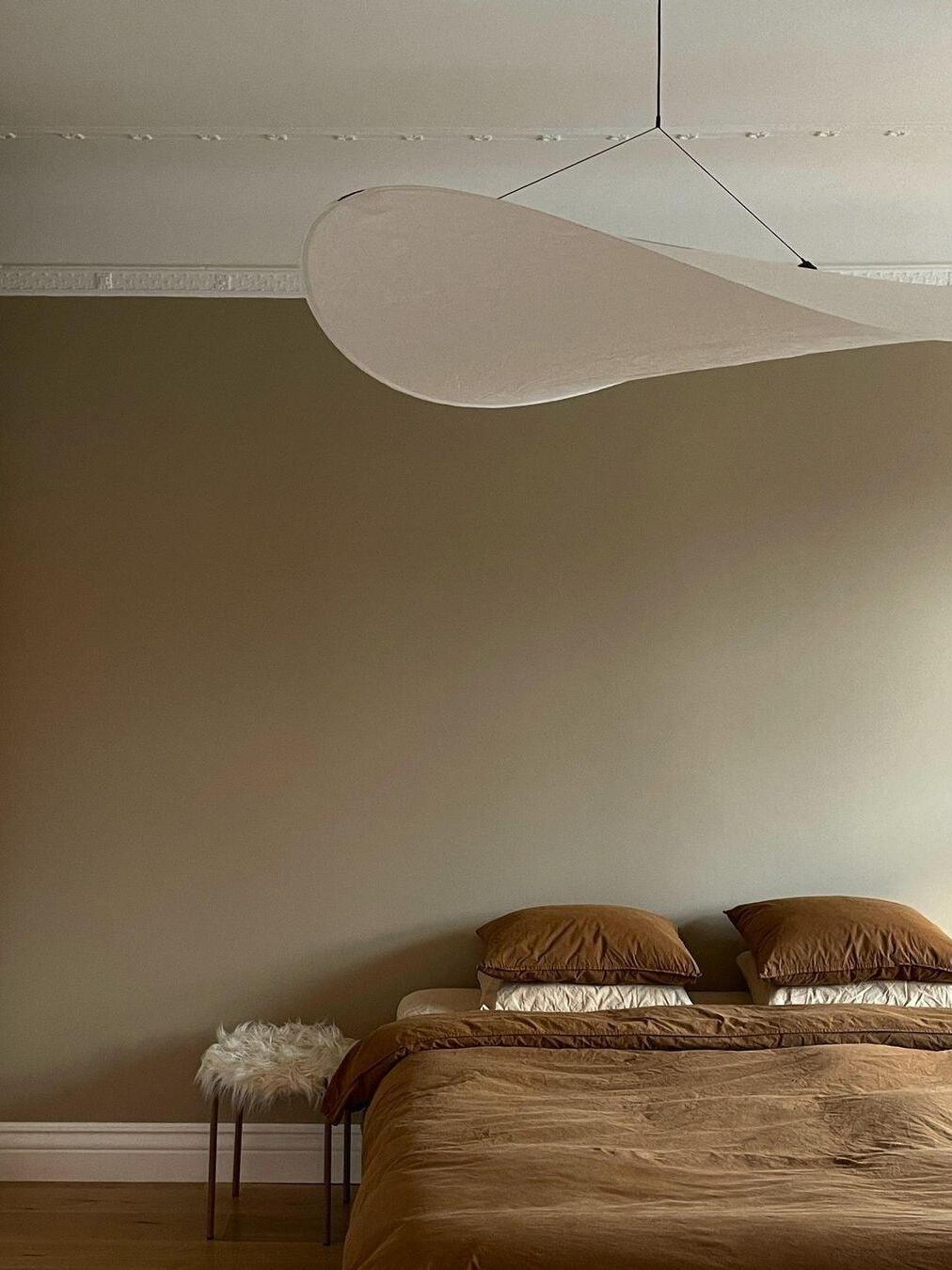 White cloud-like shade above a bed
