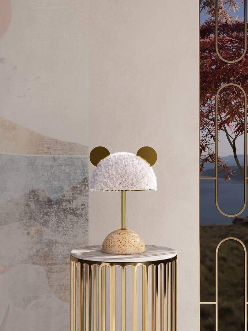 Pale textured shade and round gold-tone accents on lamp standing on wire side table