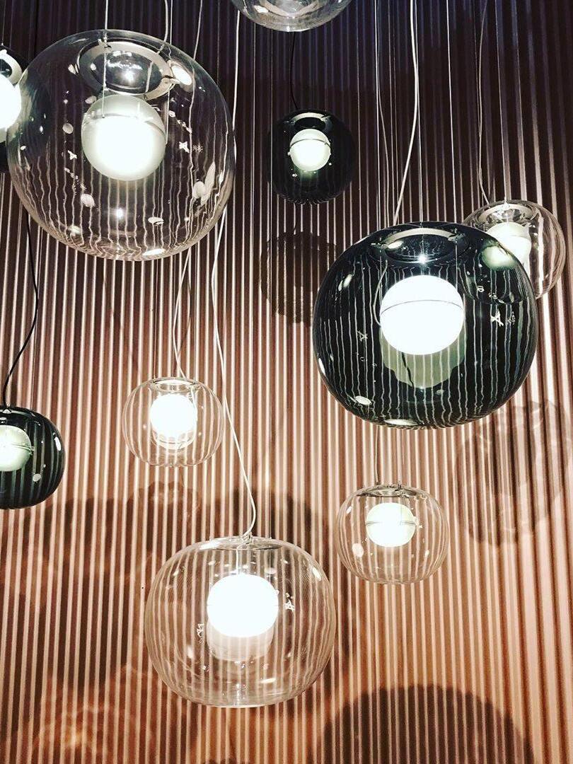 Group of glass globe lights against a slatted wall
