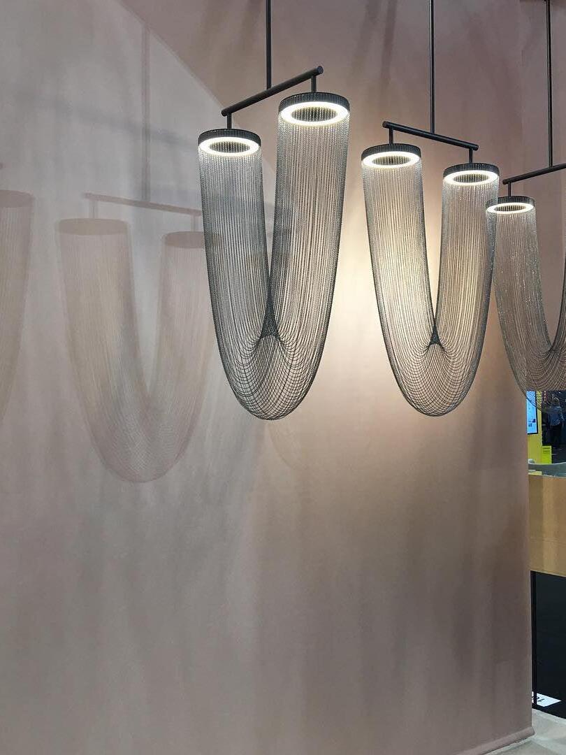 Gallery view of dark and pale chain fixtures on a display wall