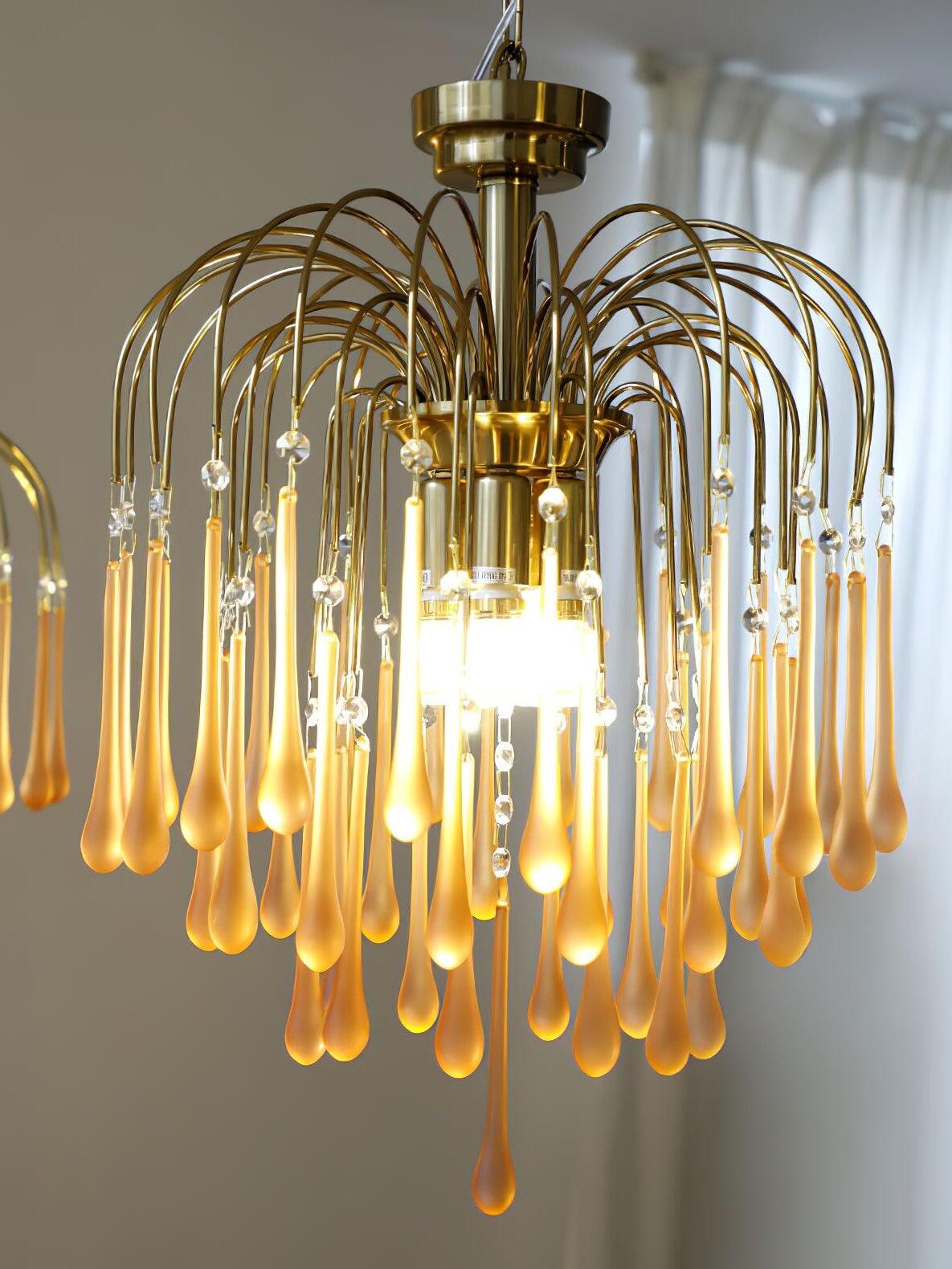 Gold-coloured curved stems and glowing long drops