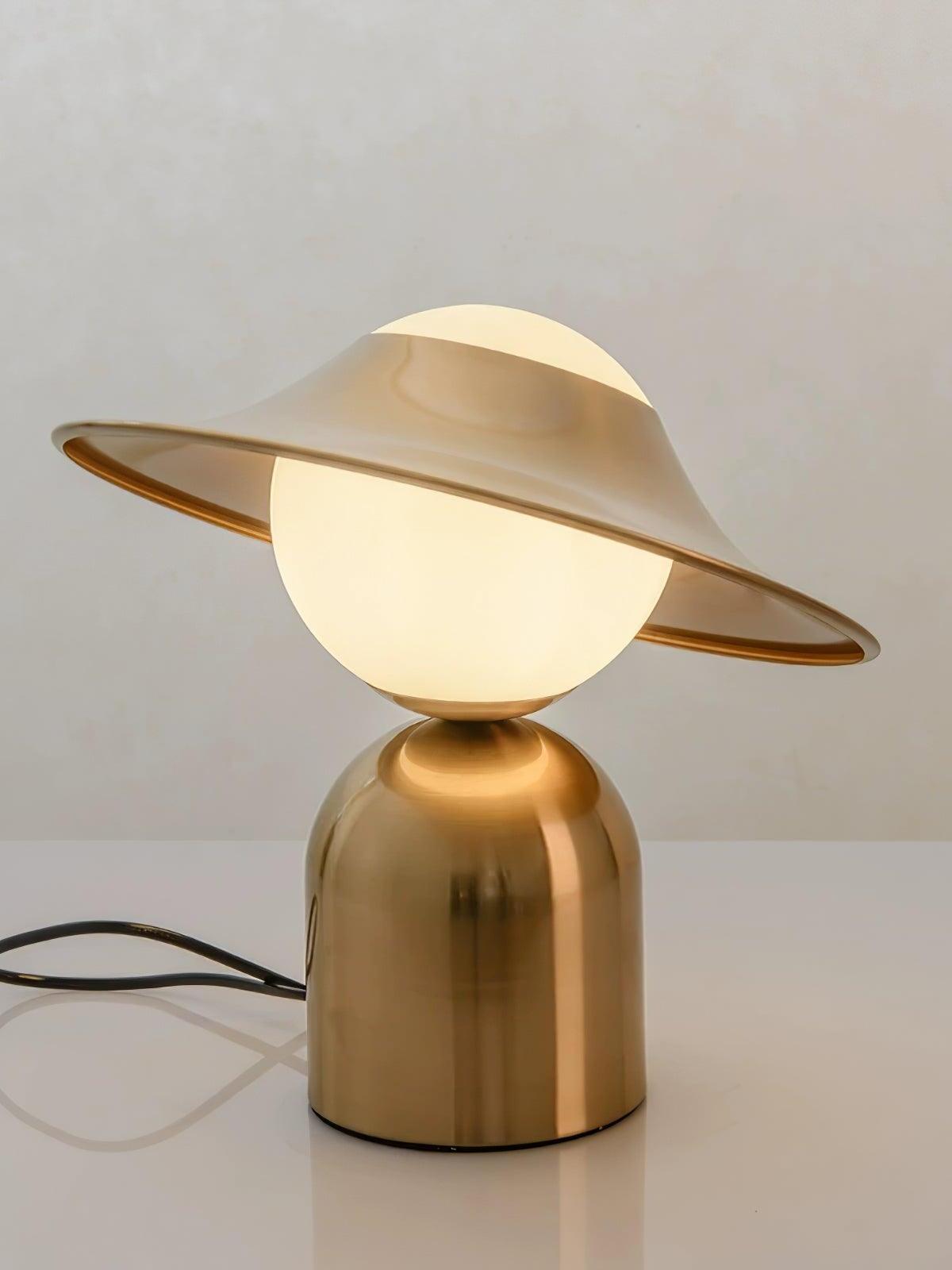 Lit white glass globe beneath tilted gold disc