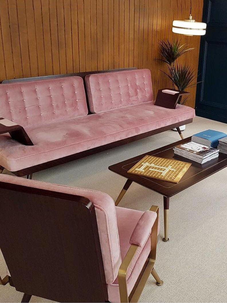 Opal-glass pendant beside a pink sofa in a living area
