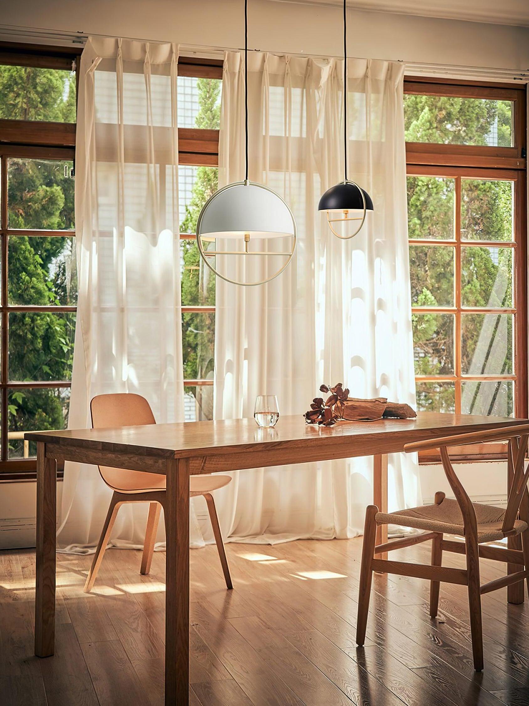 Black and white pendants above long dining table
