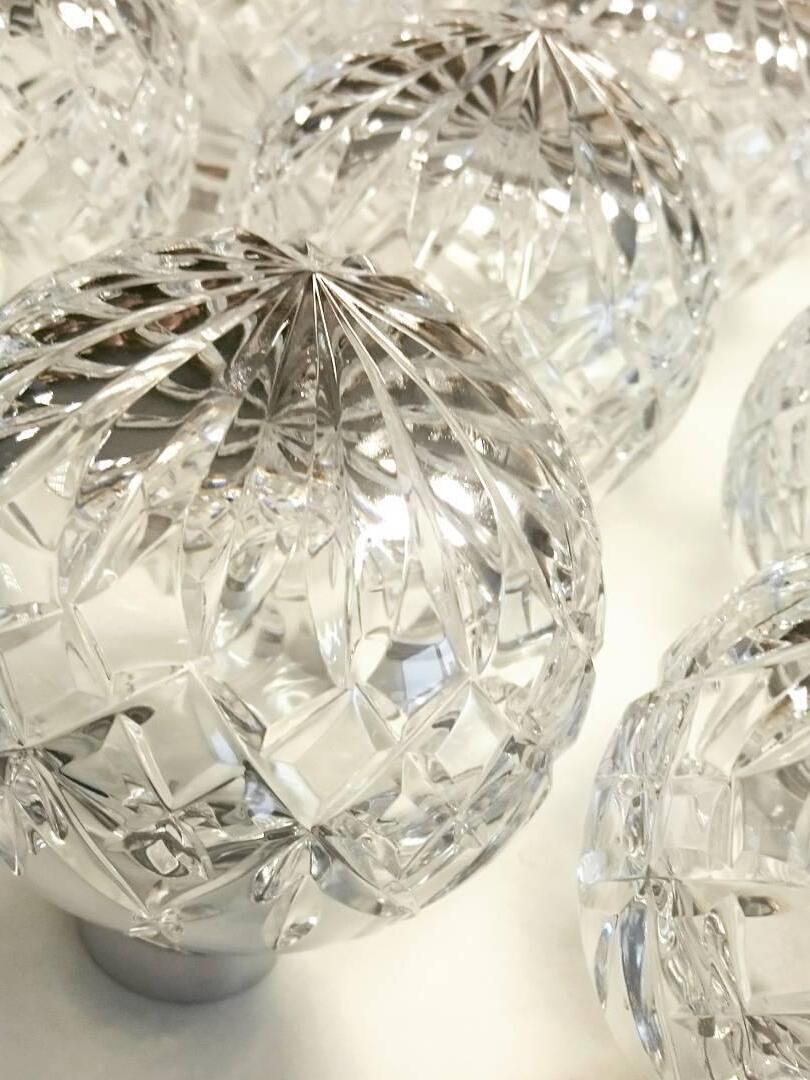 Several clear glass globes with geometric facet patterns