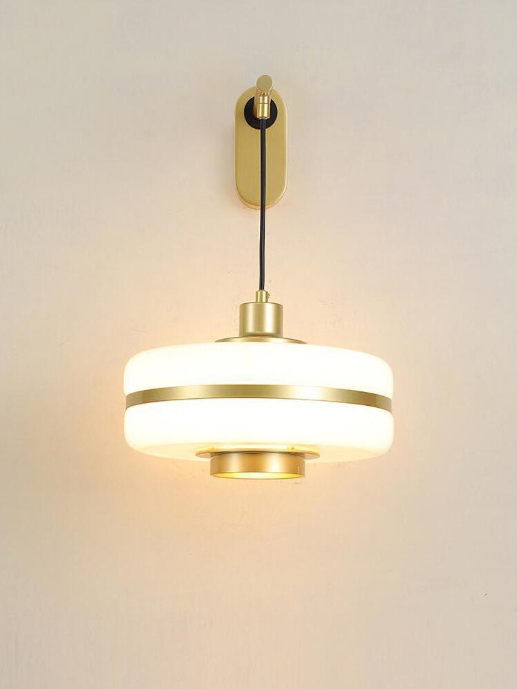 Front lit Masina shade with gold-tone band and aligned black suspension