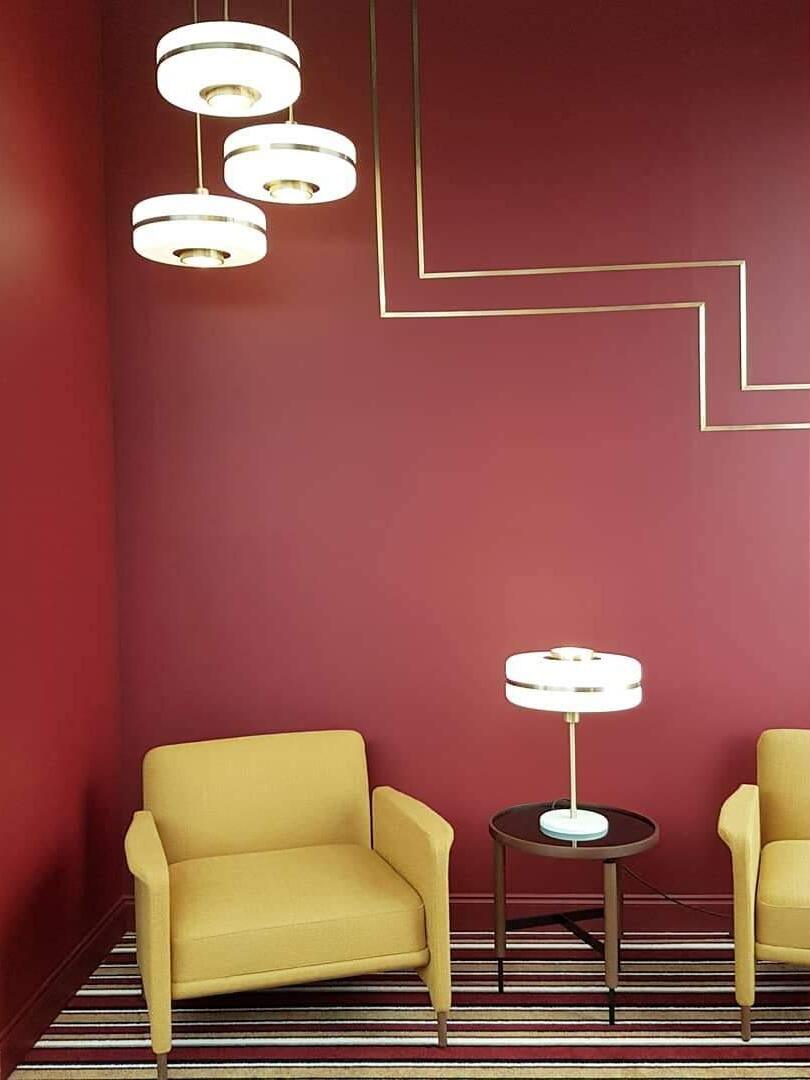 Opal-glass pendants in a room with a yellow chair and red wall