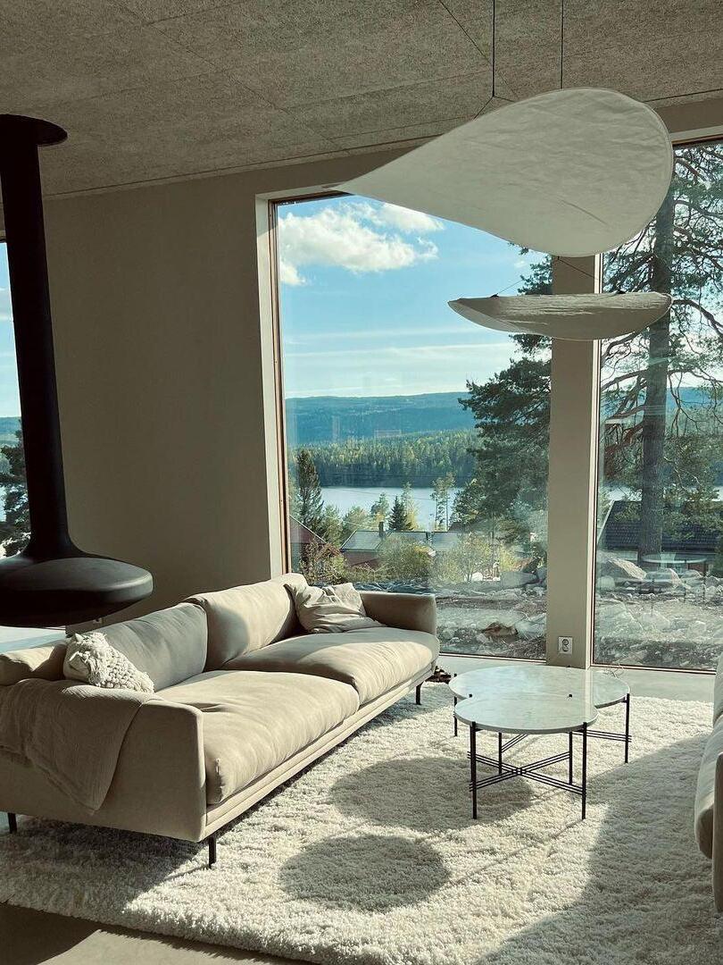 White curved shades in a lounge with large windows