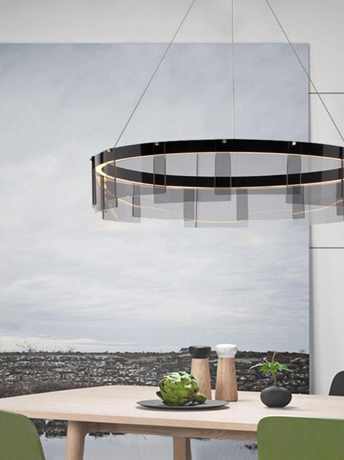 Stratos glass ring chandelier above a table with cups