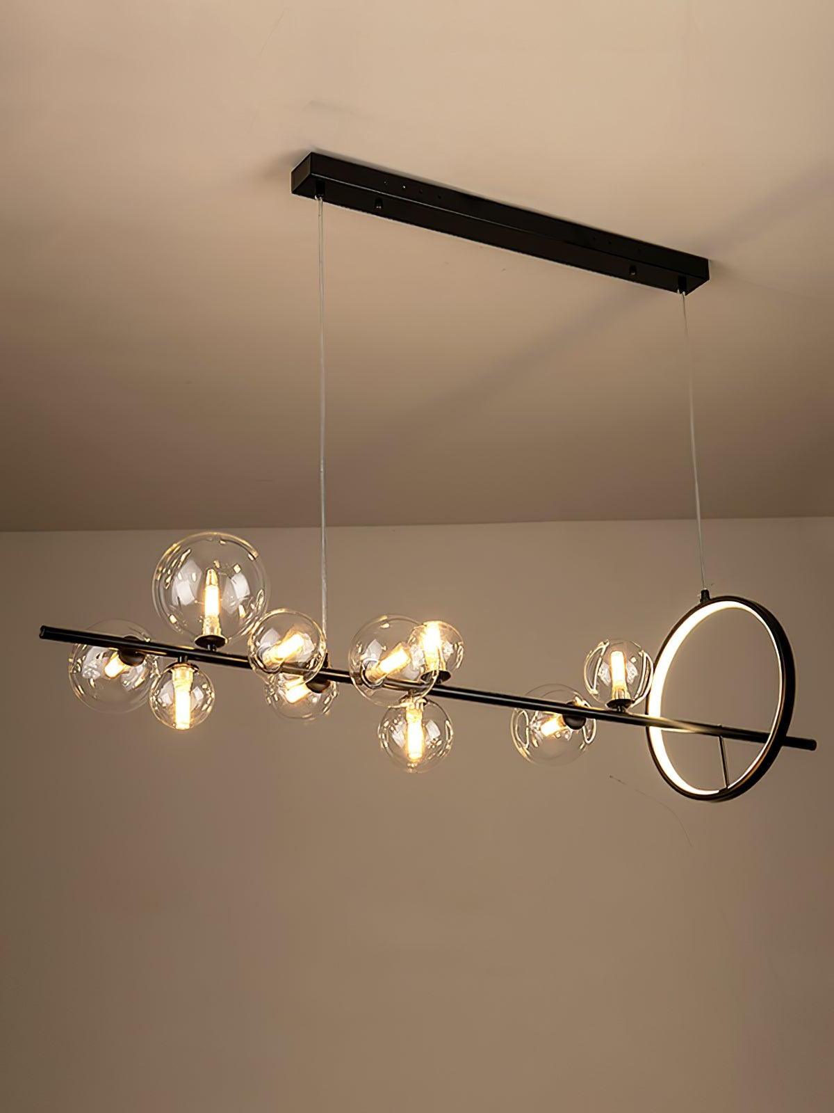 Warm-lit globes and ring suspended above a room