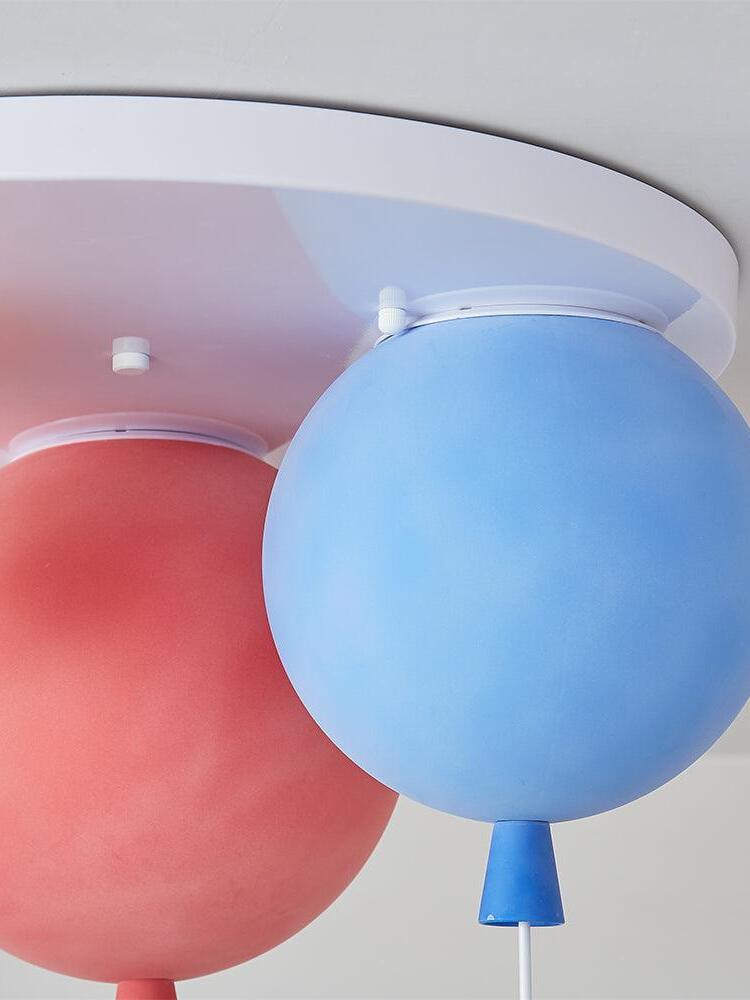 Blue and red balloon shades beneath a white ceiling plate