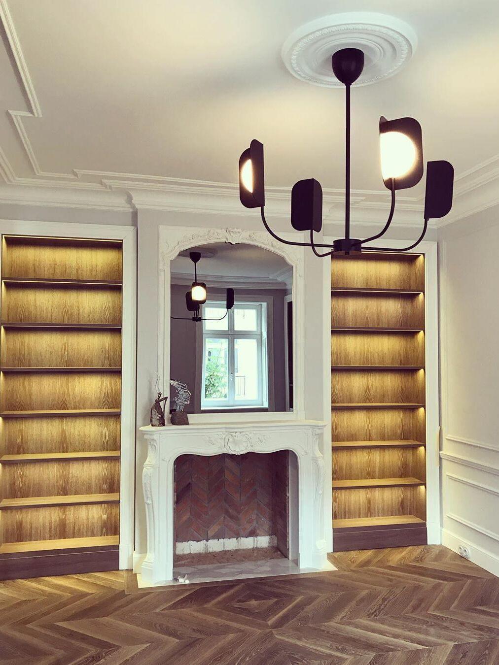 Black four-arm chandelier with a round ceiling attachment