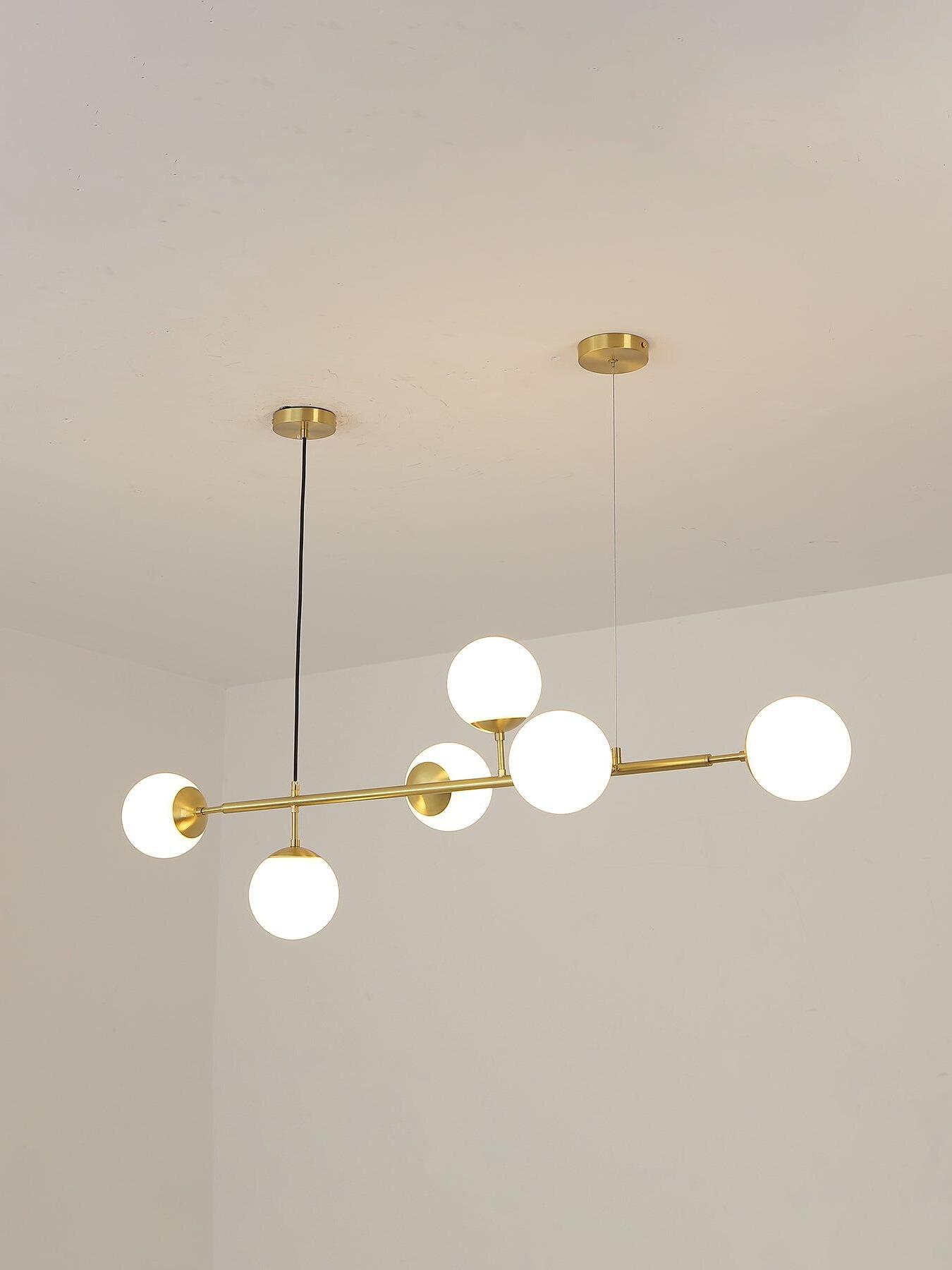 White Orb chandelier switched on