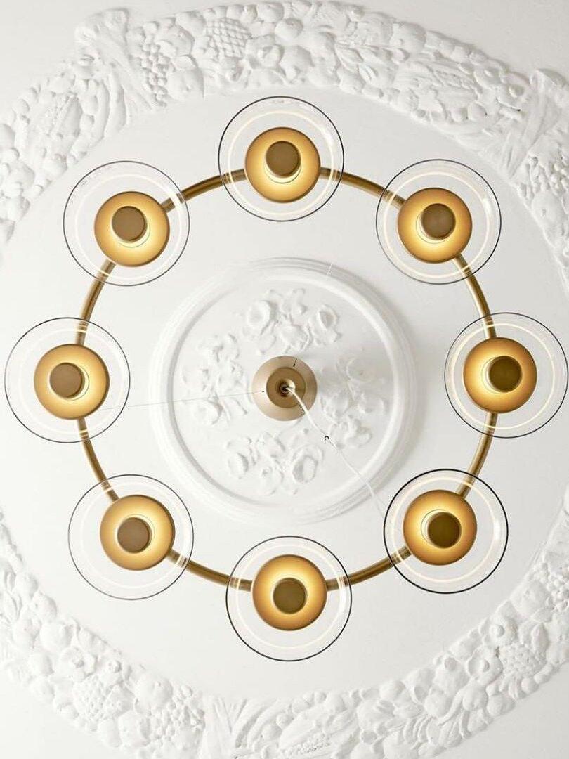 Eight illuminated circular glass shades viewed from directly below