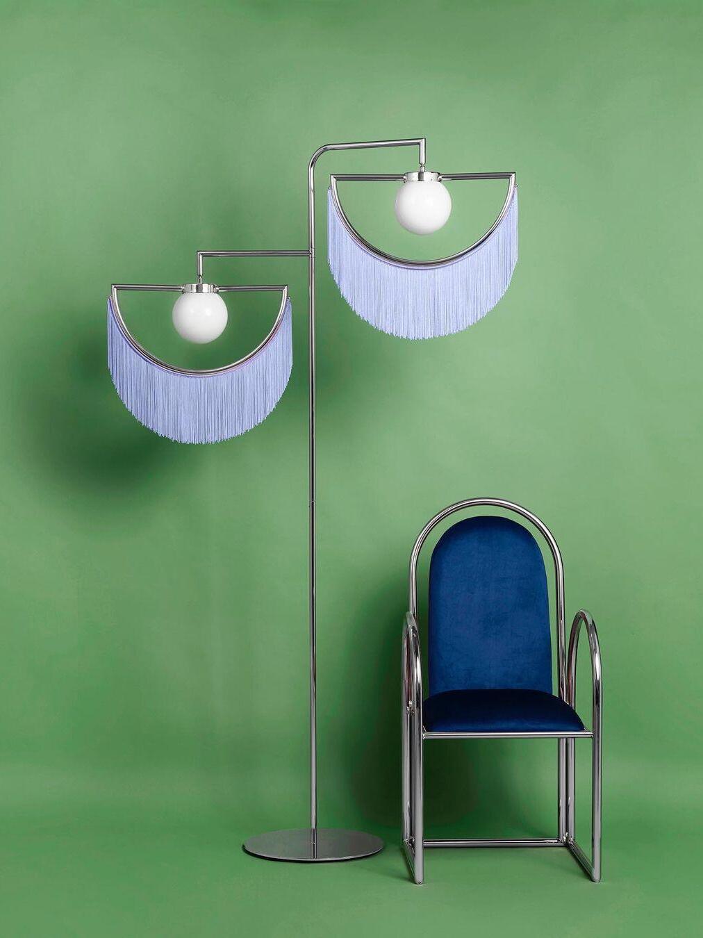 Wink pale blue fringe floor lamp beside a blue chair