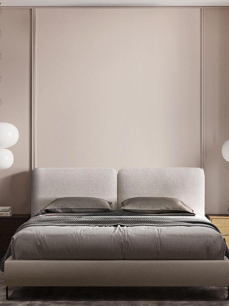 Globe lights on both sides of an upholstered bed