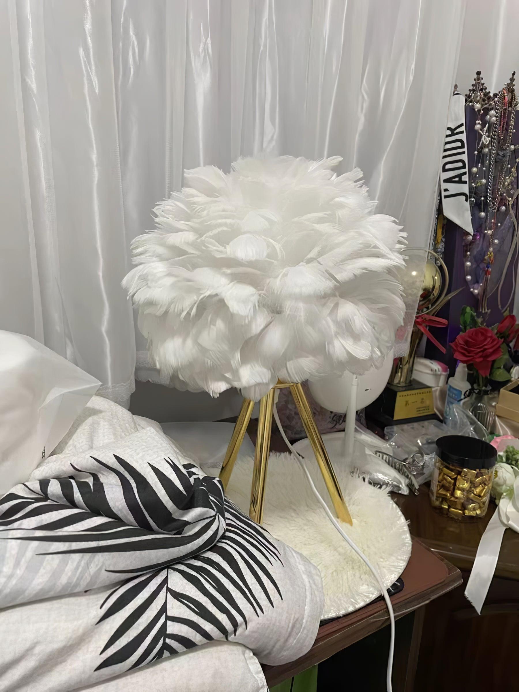 White feather lamp on round white bedside table