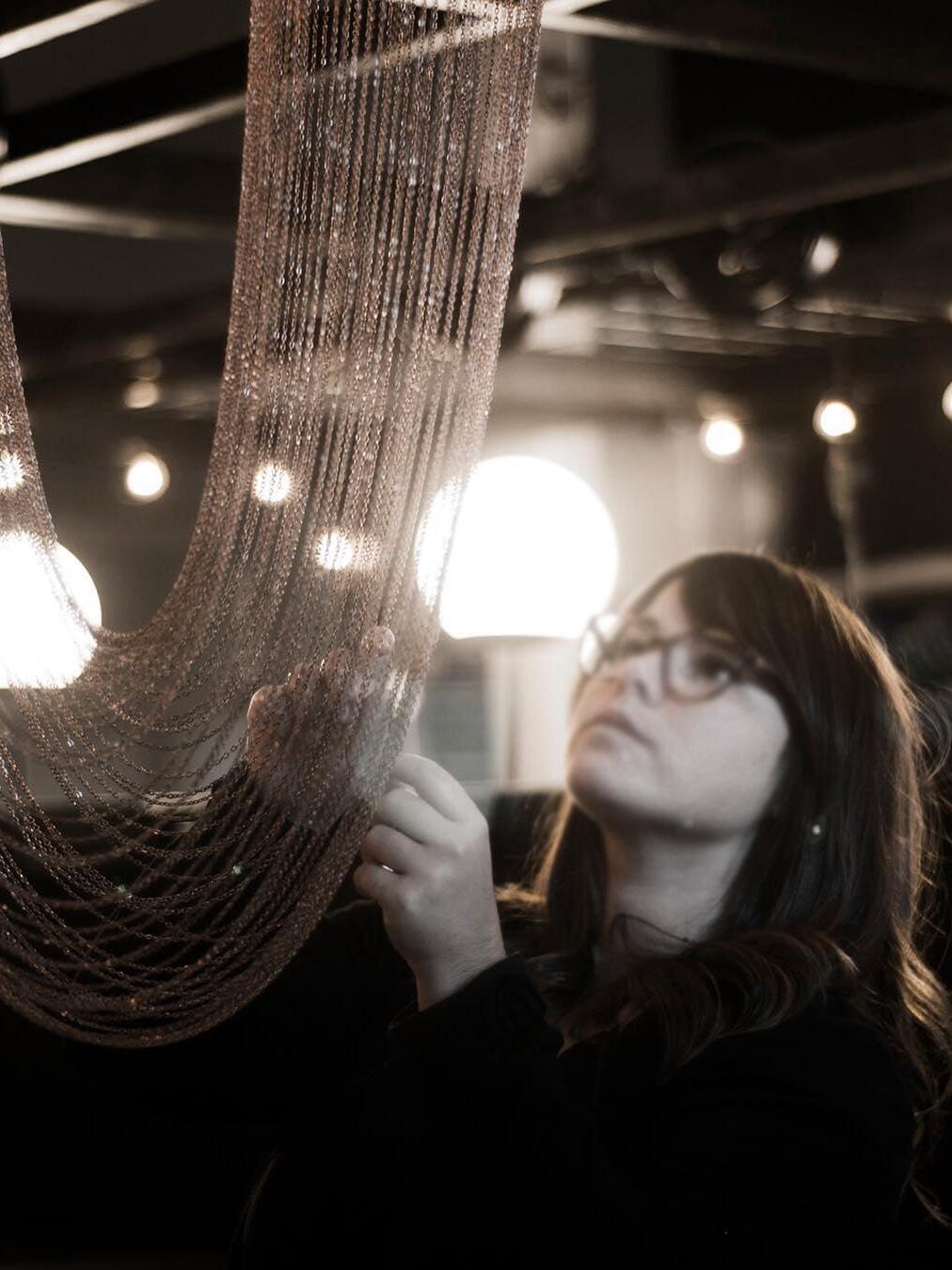 Person examining the fine hanging chains
