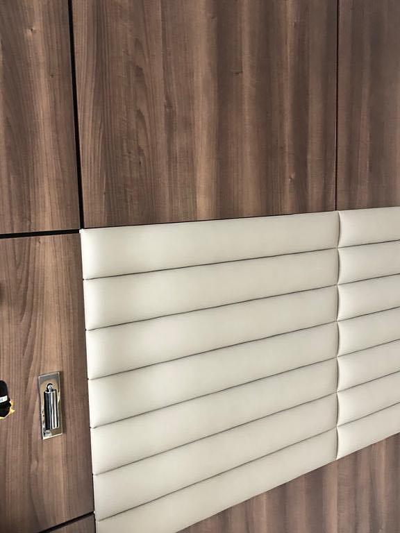 Reading lights fitted beside a padded headboard