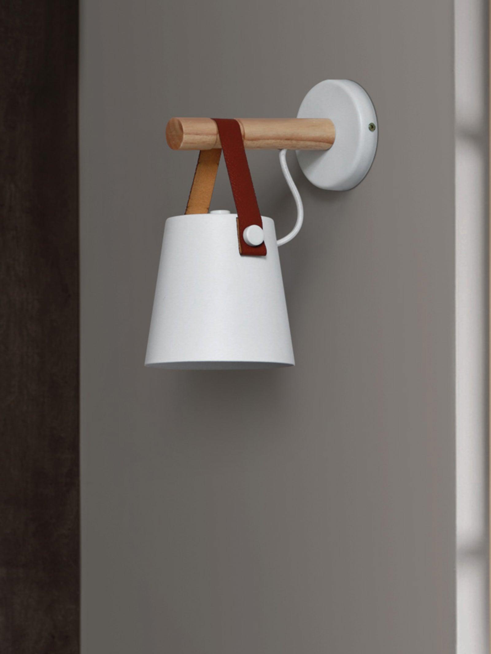 White tapered shade beneath a wood arm and round plate