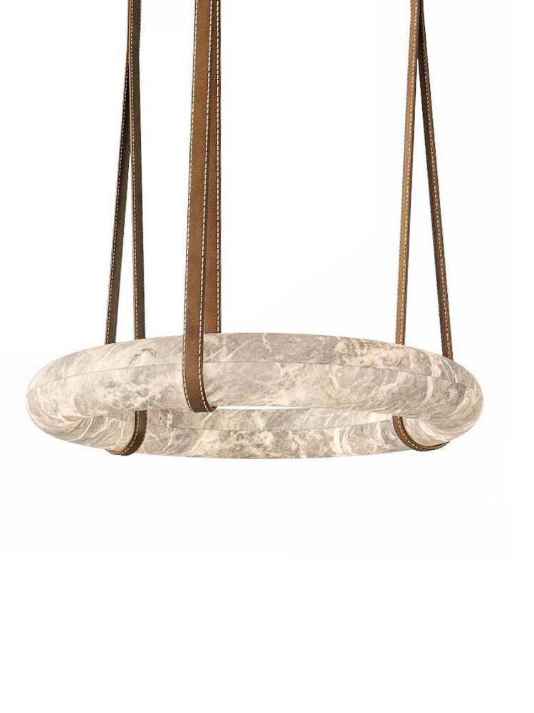 Horizontal white alabaster ring suspended from brown straps