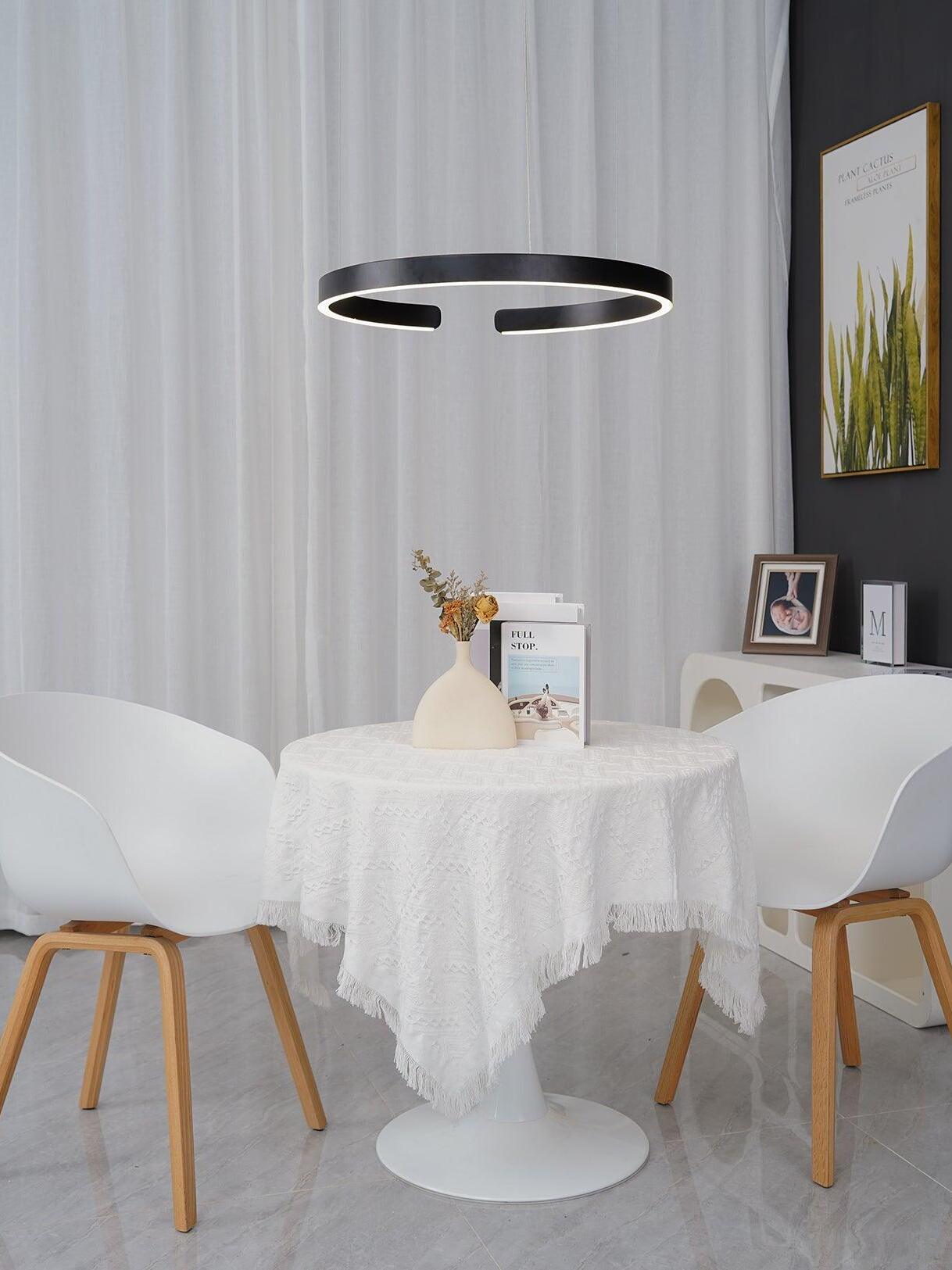 Black ring pendant above a round table