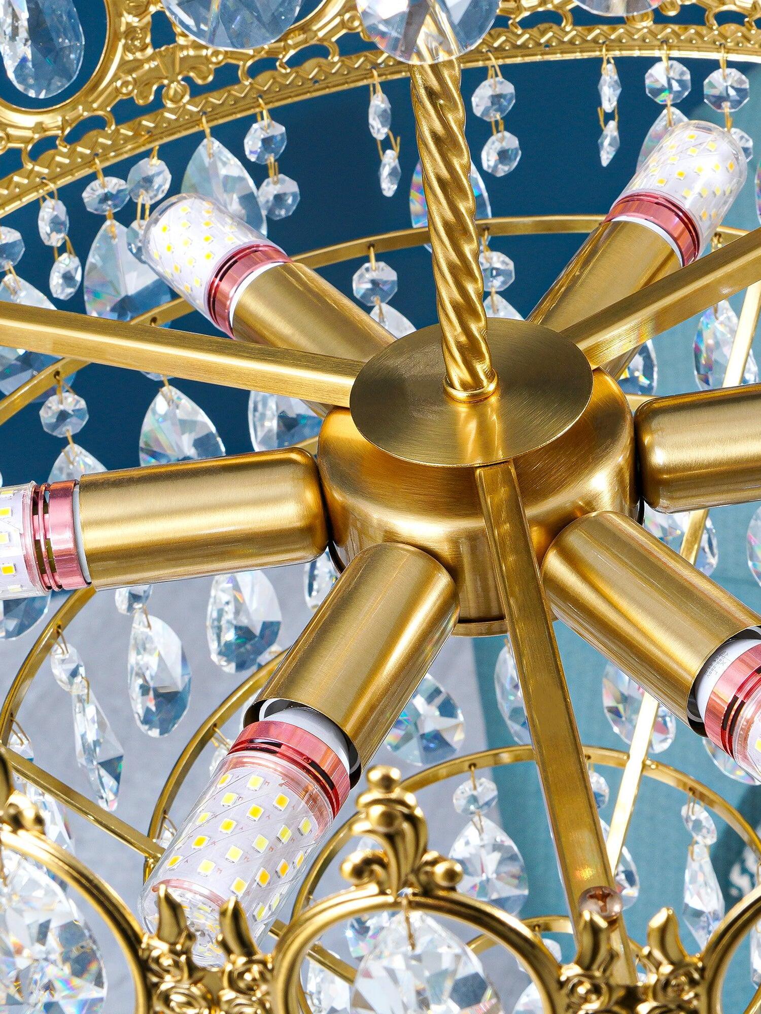 Chandelier interior with radial gold-tone bulb holders, visible LED bulbs and hanging faceted crystal pieces