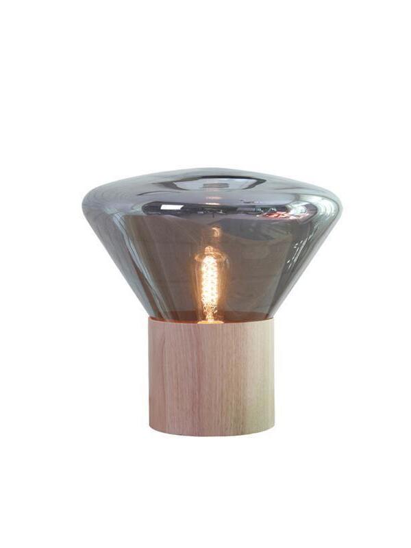 Isolated smoky glass shade with lit bulb and cylindrical wood base