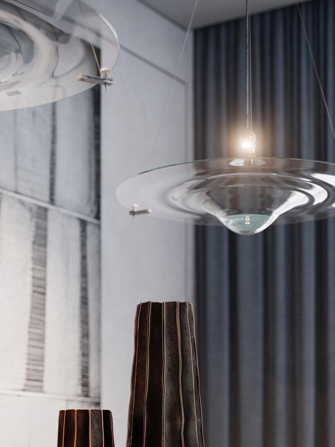 Close view of clear glass disc and thin suspension cords