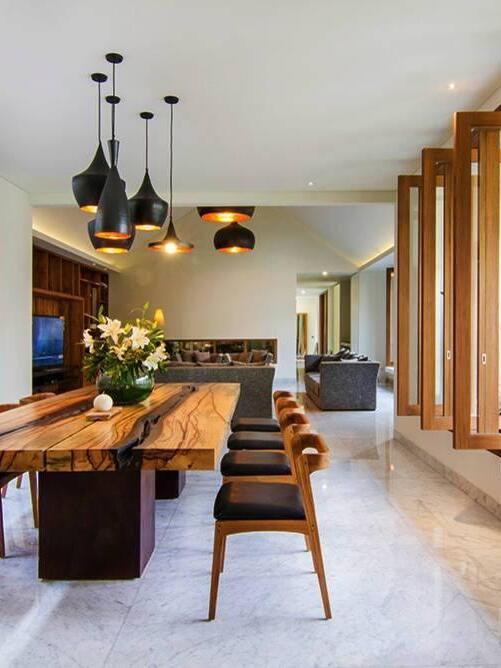 Black mixed pendants above a long wood table