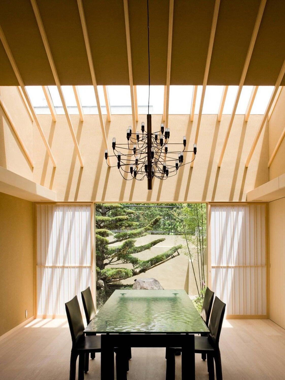 Black chandelier under exposed ceiling timbers