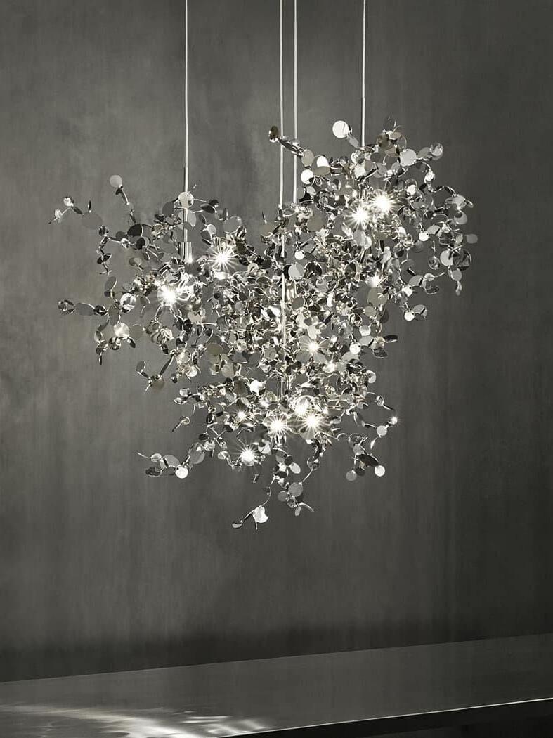Close silver disc cluster against charcoal wall and metal surface