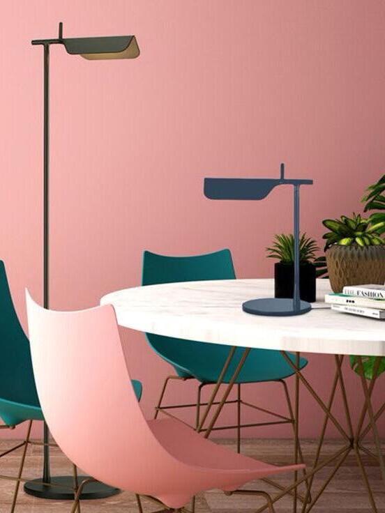 Green floor lamp and separate blue table lamp beside a pink chair