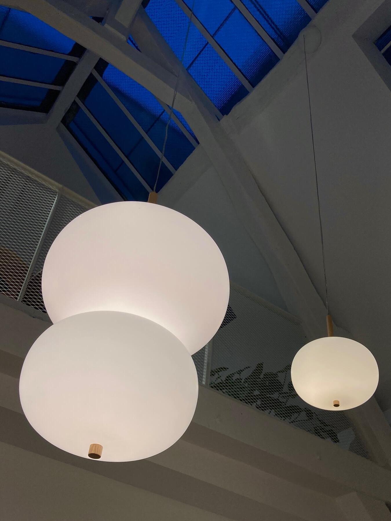 White globes viewed upward in an interior
