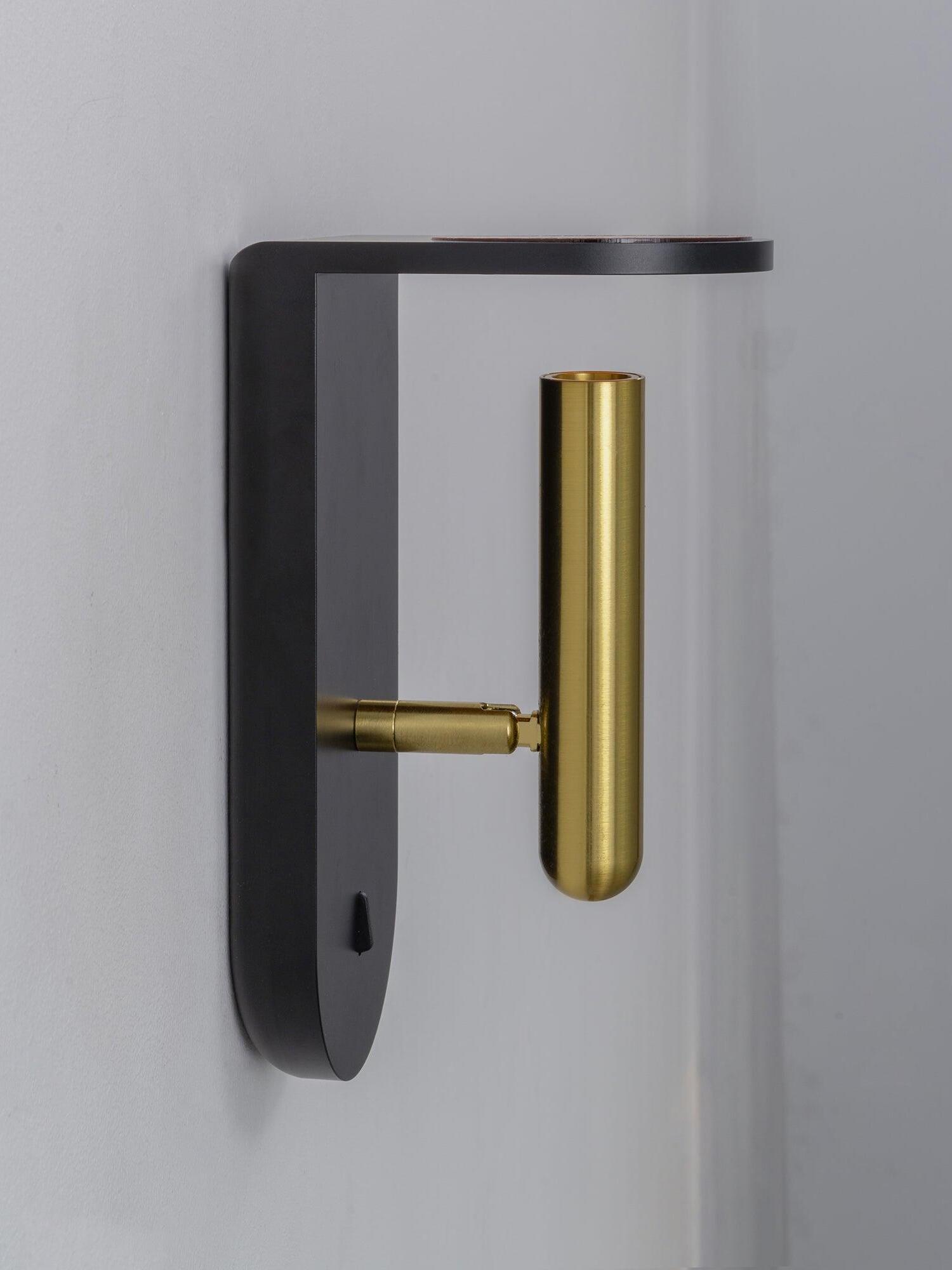 Side view of a black Nights wall light showing the backplate and gold-tone head