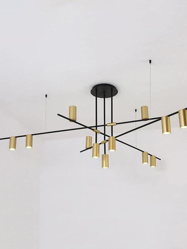 Black crossed-bar fixture with gold-coloured cylindrical heads